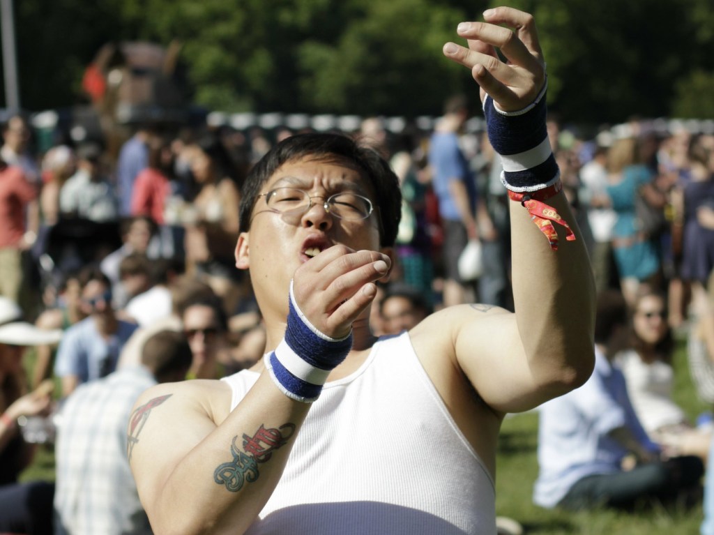 "Man playing epic air guitar at The Great GoogaMooga Festival" by WarmSleepy is licensed under CC BY 2.0.