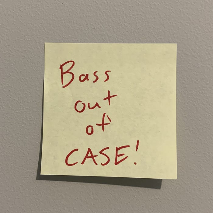 A sticky note with a reminder to remove my bass from its case.
