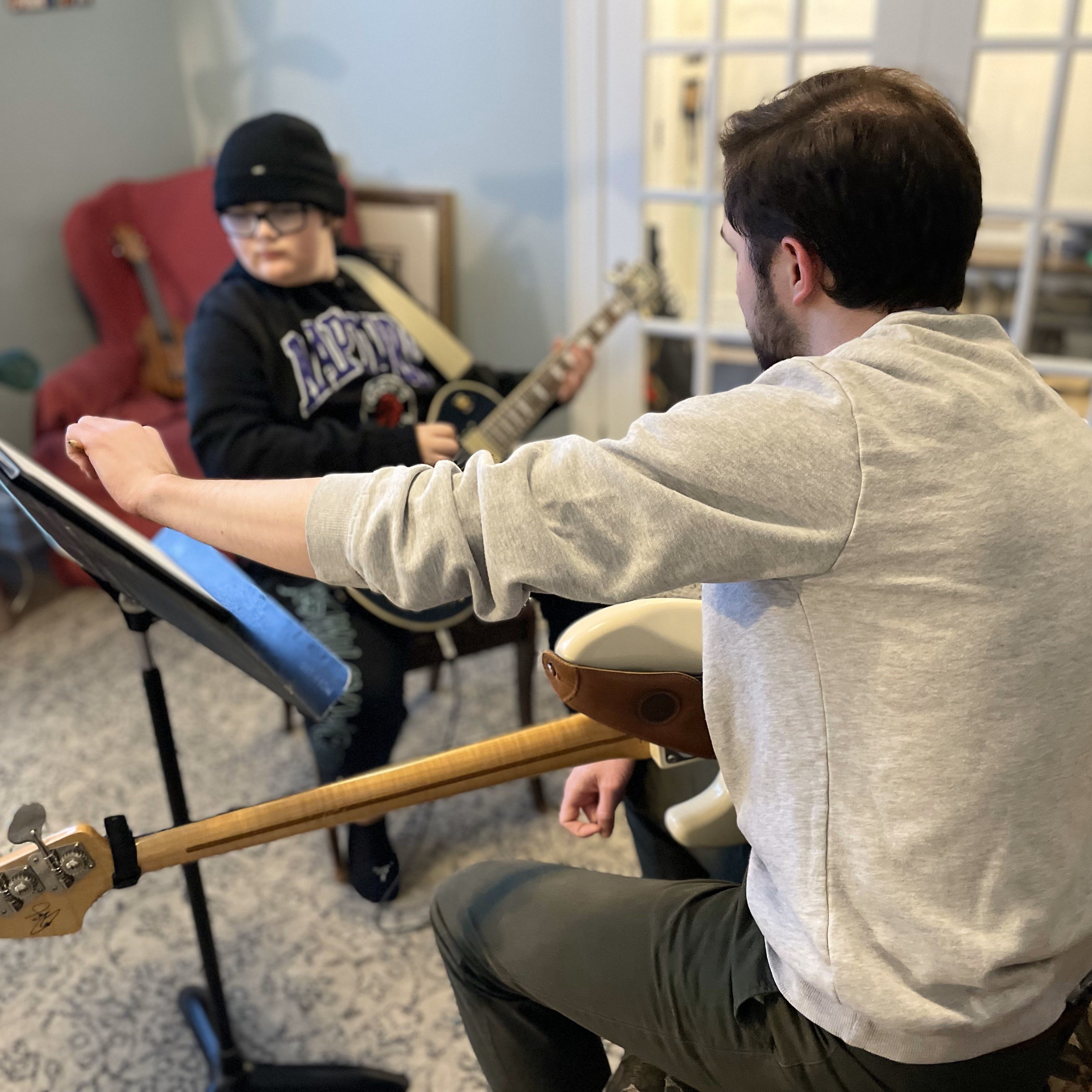 Graeme Morrison teaching guitar lessons to a young student.