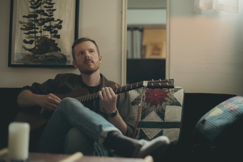 Warren Frank strums a tune on his guitar.